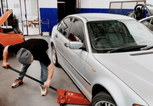 A Man Preparing His Car With Car Survival Items