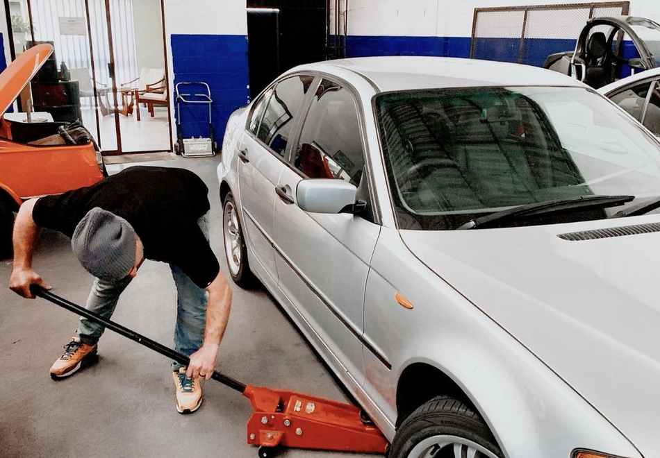 A Man Preparing His Car With Car Survival Items